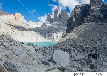 Hikers Exploring Majestic Mountain Landscape with Turquoise Lake Hikers Exploring Majestic Mountain Landscape with Turquoise Lake 112933929