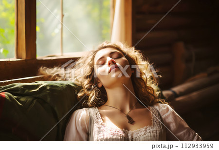 Tranquil Young Woman Relaxing in Sunlit Rustic Cabin - Serene Countryside Retreat 112933959