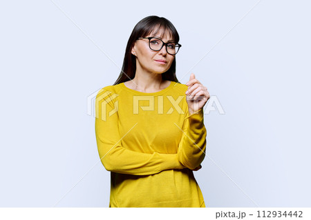 Portrait of smiling mature confident woman on white studio background 112934442