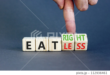 Eat less or right symbol. Concept words Eat less or Eat right on wooden cubes. Beautiful grey table grey background. Doctor hand. Healthy lifestyle and eat less or right concept. Copy space. 112936461
