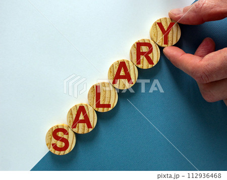 Wood circles with word 'salary' stacking as step stair on paper blue and white background, copy space. Business concept success process. Wood circles with word 'salary' stacking as step stair on paper blue and white background, copy space. Business concept success process. 112936468