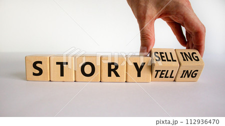 Storytelling or storyselling symbol. Businessman turns wooden cubes and changes the word 'storytelling' to 'storyselling'. Beautiful white background, copy space. Business and storytelling concept. Storytelling or storyselling symbol. Businessman turns wooden cubes and changes the word 'storytelling' to 'storyselling'. Beautiful white background, copy space. Business and storytelling concept. 112936470