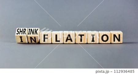 Inflation or shrinkflation symbol. Concept words Inflation Shrinkflation on beautiful wooden blocks. Beautiful grey table grey background. Business inflation shrinkflation concept. Copy space 112936485