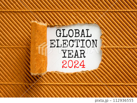 Global election year 2024 symbol. Concept words Global election year 2024 on beautiful white paper. Beautiful brown background. Business Global election year 2024 concept. Copy space Global election year 2024 symbol. Concept words Global election year 2024 on beautiful white paper. Beautiful brown background. Business Global election year 2024 concept. Copy space 112936555