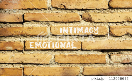 Emotional intimacy symbol. Concept words Emotional intimacy on beautiful brown brick wall. Beautiful brown brick wall background. Psychology emotional intimacy concept. Copy space. 112936655