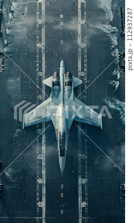 Fighter jet on the runway of an aircraft carrier in the open ocean 112937287