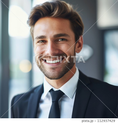Smiling European businessman 20-30 years old, active business man against the background of his office 112937429