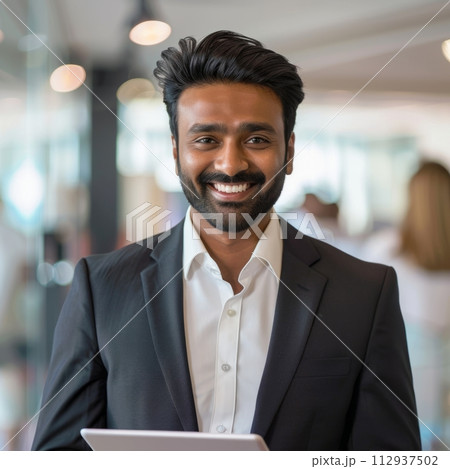 Smiling Hindu businessman 30-40 years old, active business man against the background of his office 112937502