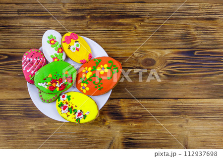 Egg shaped easter gingerbread cookies on wooden table. Top view. Sweets for celebrate Easter Egg shaped easter gingerbread cookies on wooden table. Top view. Sweets for celebrate Easter 112937698