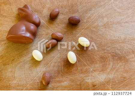 Easter chocolate bunny and chocolate eggs on wooden background. Top view Easter chocolate bunny and chocolate eggs on wooden background. Top view 112937724
