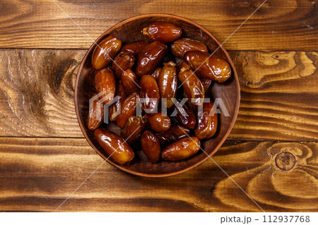 Dried dates fruit on wooden table. Top view Dried dates fruit on wooden table. Top view 112937768