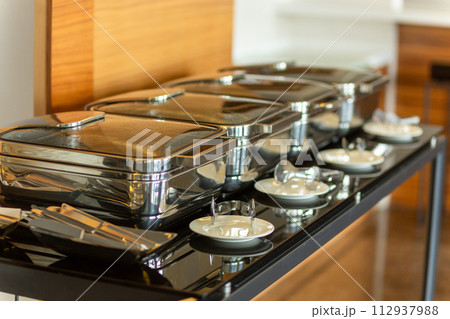 Row of closed chafing dishes Row of closed chafing dishes 112937988