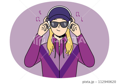 Girl in retro clothes listen to music in headphones 112940620