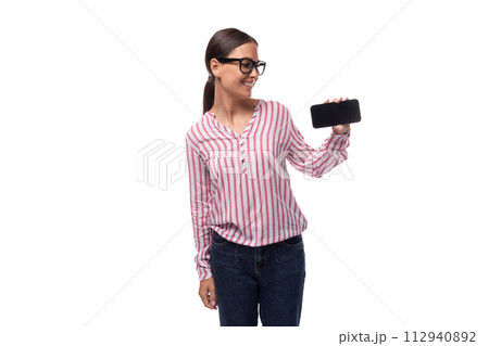 young lady office employee dressed in pink white blouse and jeans shows smartphone screen with 112940892