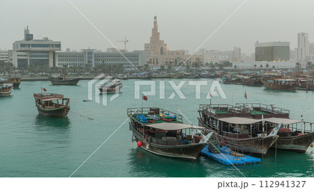Evening at Doha Bay day to night timelapse with Traditional Wooden Dhow Fishing Boats. Evening at Doha Bay day to night timelapse with Traditional Wooden Dhow Fishing Boats. 112941327