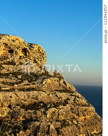 Beautiful sunset at Blue Grotto , complex of seven caves found along the southern coast of Malta. Beautiful sunset at Blue Grotto , complex of seven caves found along the southern coast of Malta. 112942057