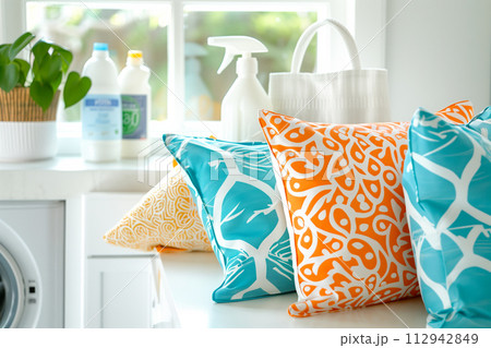 Stack of clean towels on modern washing machine with blurred background. The towels showcasing soft and fluffy textures 112942849