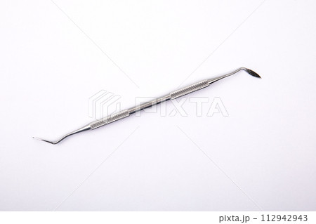 Dental instrument on a white background. Steel 112942943