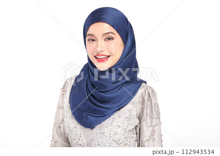 Beautiful young asian muslim woman wearing a blue hijab on white background, 112943534