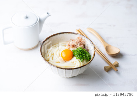 udon noodle with green onion, bonito powder and egg yolk 112943780