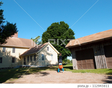 Man wearing a hat, long sleeve t-shirt, pants, and slippers Handstands at Historic Jonathan Trumbull jr. House Museum 112943811