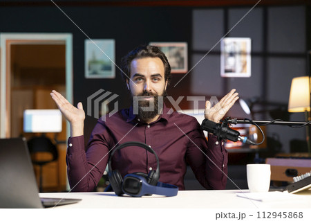 Media star excited to review newly launched wireless headphones, comparing features with older models. Technology internet show host filming video online channel, analyzing listening devices 112945868