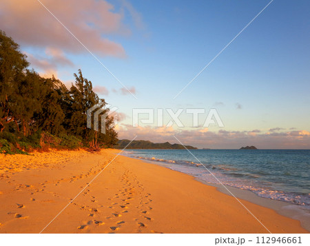 Gentle waves crash on Waimanalo Beach on Oahu, Hawaii at dawn Gentle waves crash on Waimanalo Beach on Oahu, Hawaii at dawn 112946661