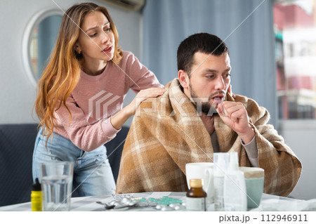 Sick man sitting with wife at home 112946911