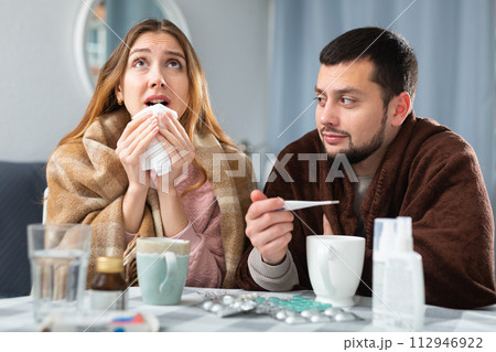 Sick couple suffering from flu at home Sick couple suffering from flu at home 112946922