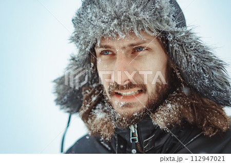 a bearded man in an earflap in winter 112947021