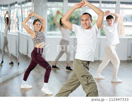Smiling young Asian dancer practicing flamenco in dance studio 112947333