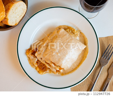 Traditional Italian dish is lasagna baked in oven under cheese crust. 112947726