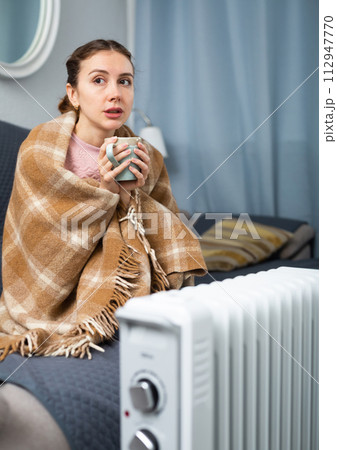 Woman feeling cold at home in winter Woman feeling cold at home in winter 112947770