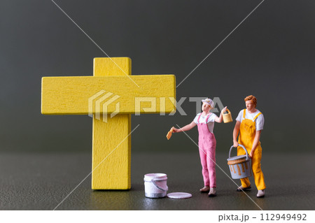 Good Friday concept, Miniature people, A yellow cross painted by an artist Good Friday concept, Miniature people, A yellow cross painted by an artist 112949492
