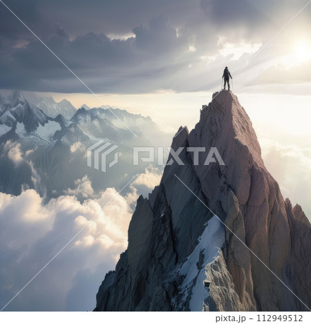 Man standing on top of a mountain and looking on impressive skies. An inspiring photo, conveying courage and determination. Man standing on top of a mountain and looking on impressive skies. An inspiring photo, conveying courage and determination. 112949512