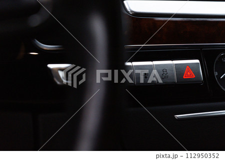 Red emergency button Interior of modern luxury car. Details of automatic transmission gear shift, multimedia control system, car control panel, Air Vent and dashboard inside. Prestige sport automobile 112950352