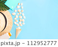 Summer holidays with seashells, palm leaves and straw hat. Blue background with copy space. Top view. Place for text. 112952777