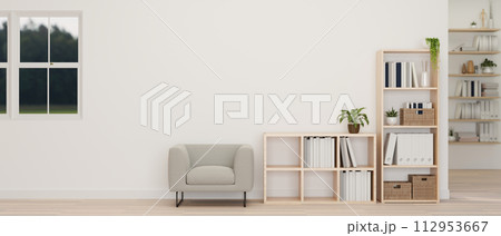 A minimalist white living room features a grey armchair, shelves, a white wall, and a parquet floor. A minimalist white living room features a grey armchair, shelves, a white wall, and a parquet floor. 112953667