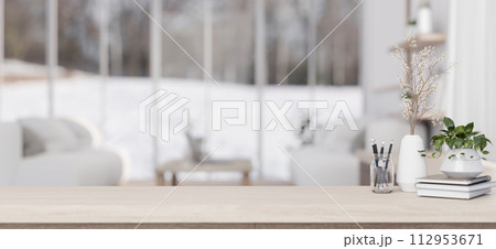A minimalist wooden table in a contemporary minimalist living room. 112953671