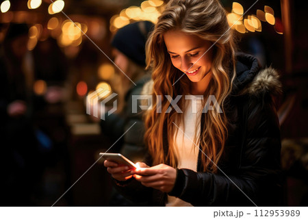Young female student talking online using a smartphone Young female student talking online using a smartphone 112953989