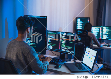 asian woman  and Indian man Developer team working  about devops programming software data online  at night in office 112956134