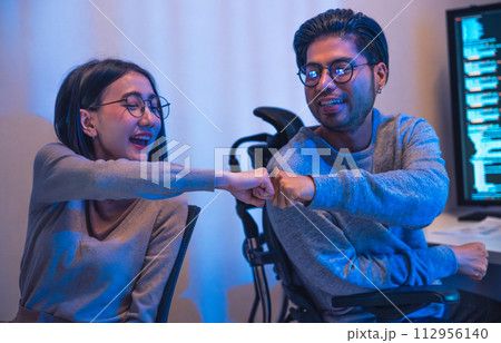 asian and Indian Developer team clapping hand for project success with software computer at night in office asian and Indian Developer team clapping hand for project success with software computer at night in office 112956140