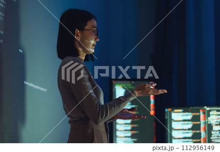 asian woman developer presentation about coding software data with devops team at night in office asian woman developer presentation about coding software data with devops team at night in office 112956149
