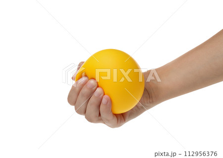 PNG, yellow ball, smiley clenched in hand, isolated on white background. 112956376