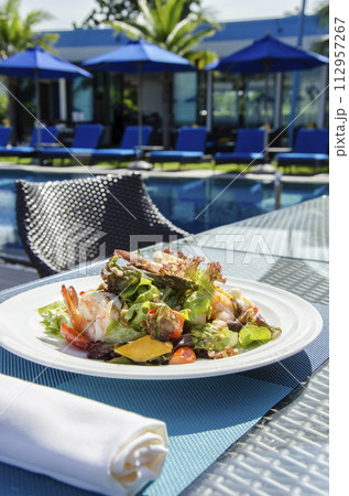 Vegan Yoga Girl Holds Healthy Whole Foods Plant Based Meal with Colorful Greens Quinoa Next to Swimming Pool Vegan Yoga Girl Holds Healthy Whole Foods Plant Based Meal with Colorful Greens Quinoa Next to Swimming Pool 112957267