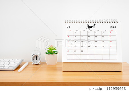 April 2024, Monthly desk calendar for 2024 year on wooden table. 112959668