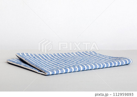 top view with blue kitchen napkin isolated on table background. Folded cloth for mockup with copy space, Flat lay. Minimal style 112959893