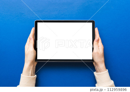 female teen hands using tablet pc with white screen, Mockup image of woman hand holding white tablet pc with blank white screen at home female teen hands using tablet pc with white screen, Mockup image of woman hand holding white tablet pc with blank white screen at home 112959896