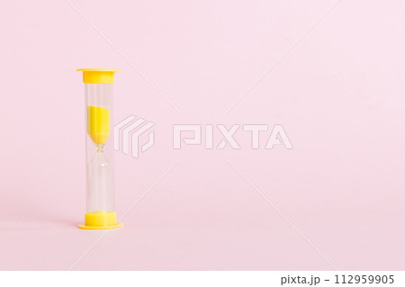 hourglass on the table, sand clock as time passing concept for business deadline, copy space 112959905