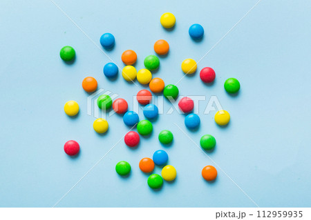 Mixed collection of colorful candy, on colored background. Flat lay, top view. frame of colorful chocolate coated candy 112959935
